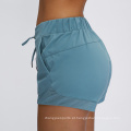 Hot Solid Color Yoga Shorts Lacas femininas respiráveis ​​com bolsos